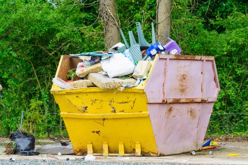 Rubbish collection team loading waste for a booked service