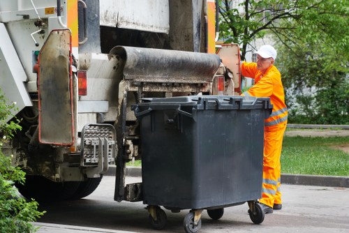 Local waste collectors handling access challenges in a London street
