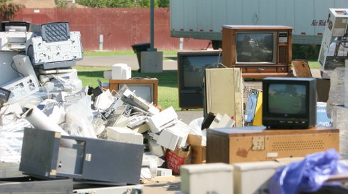 Professional junk removal service managing access in a London flat block